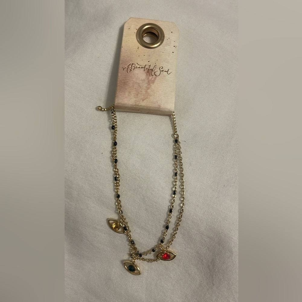 Gold plated bracelet with eye charms.